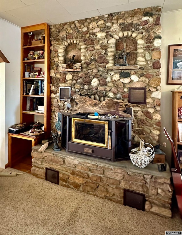 unfurnished living room with ornamental molding, carpet floors, and a fireplace