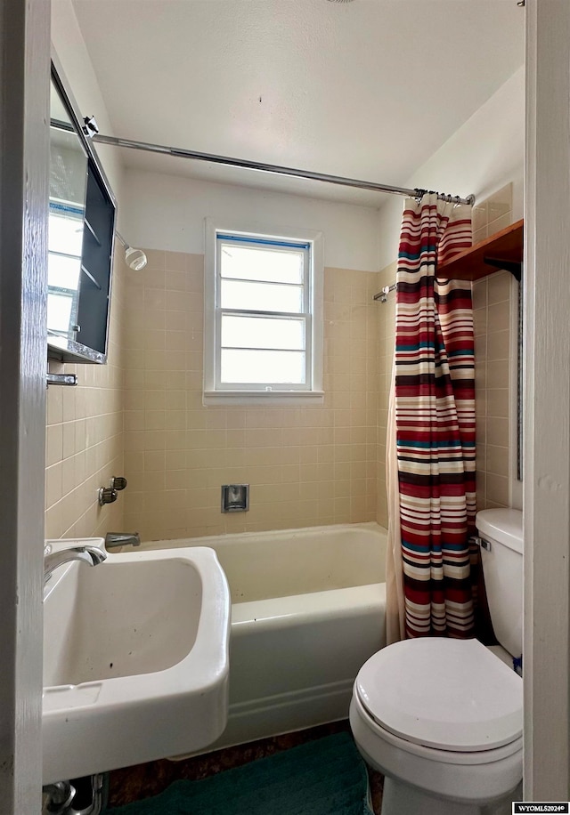 full bathroom with shower / tub combo with curtain, sink, and toilet