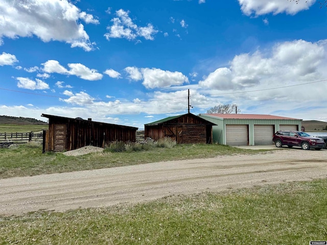 view of front of property with an outdoor structure and a garage