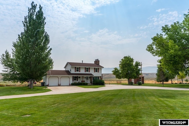 view of front facade with a garage and a front lawn