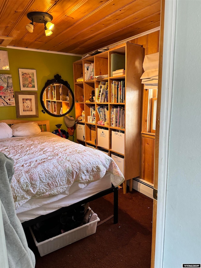 bedroom with wooden ceiling, a baseboard radiator, carpet floors, and crown molding