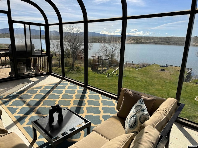 sunroom / solarium featuring a water view and plenty of natural light