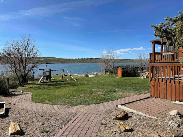 view of yard with a playground and a water view