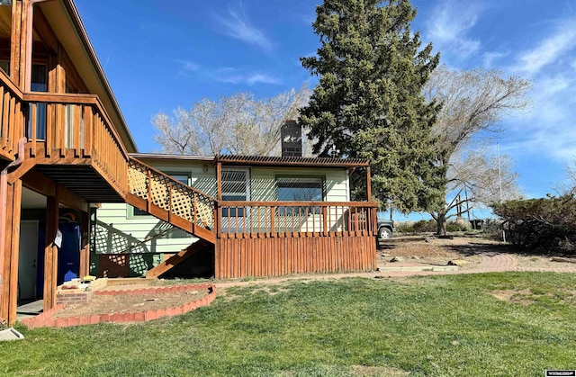 exterior space with a deck and a lawn