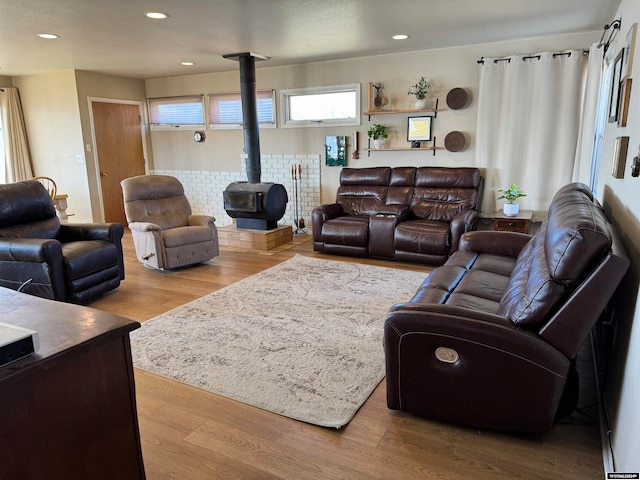 living room featuring wood-type flooring and a wood stove