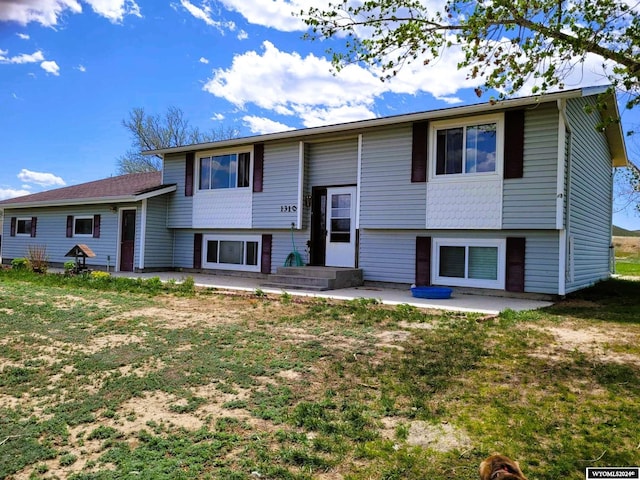 view of front of house featuring a front lawn and a patio area