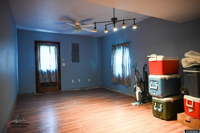 interior space featuring ceiling fan, track lighting, and light wood-type flooring