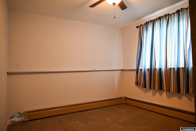 empty room with ceiling fan, carpet flooring, and a baseboard heating unit