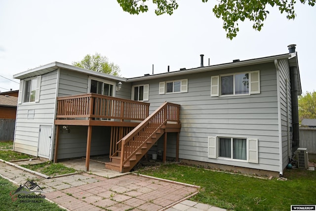 back of property featuring central AC unit, a yard, a patio area, and a wooden deck