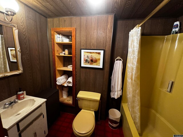 full bathroom featuring shower / bath combo, wooden ceiling, wooden walls, vanity, and toilet