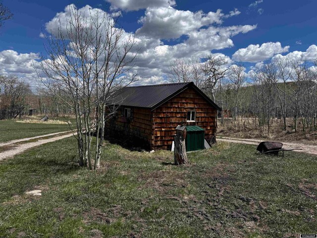 view of shed / structure with a yard