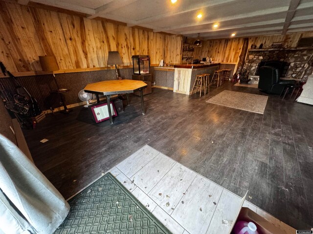 interior space featuring wooden walls, wood-type flooring, and a wood stove