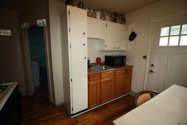 kitchen featuring dark hardwood / wood-style flooring, white cabinetry, and sink