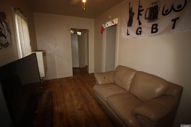 living room featuring hardwood / wood-style floors and ceiling fan