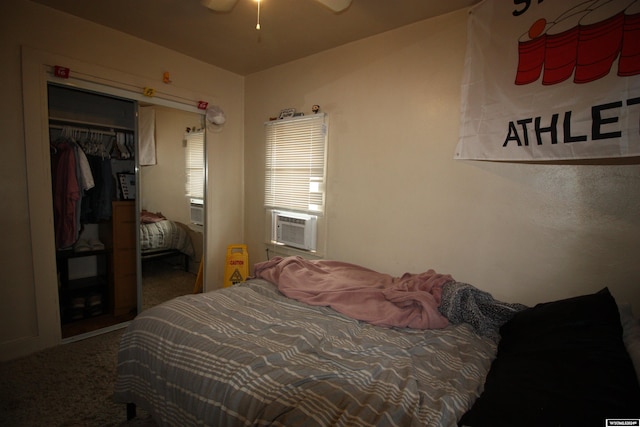 carpeted bedroom with ceiling fan, cooling unit, and a closet