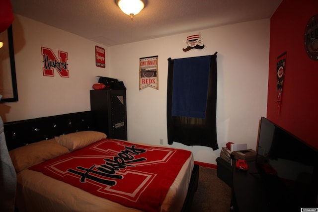 carpeted bedroom with a textured ceiling