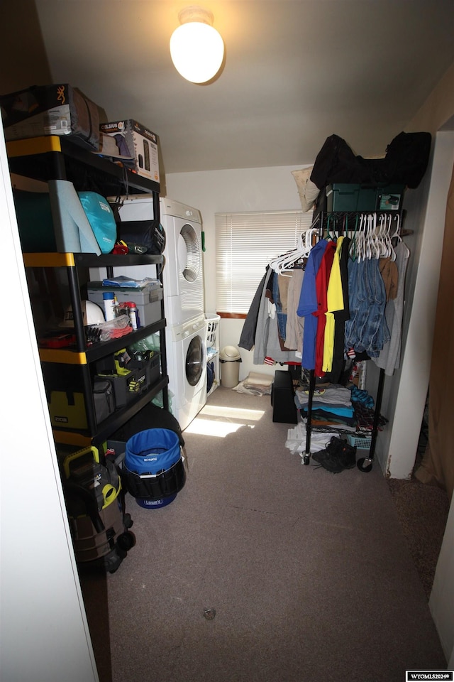 walk in closet with stacked washer and dryer and carpet