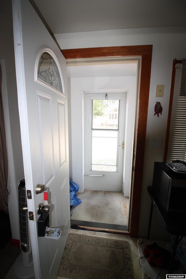 doorway featuring carpet floors