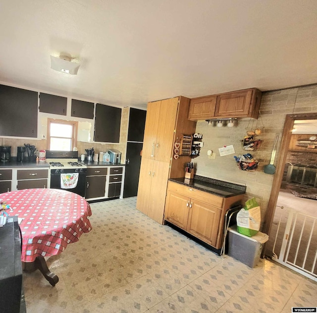 kitchen featuring white range with gas cooktop