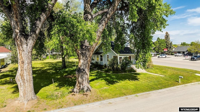 obstructed view of property featuring a front lawn