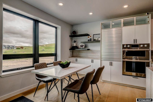 dining space with light hardwood / wood-style floors