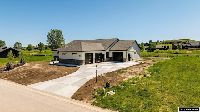 view of front of home featuring a garage and a front lawn