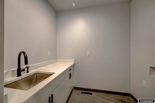 interior space featuring tile flooring, sink, and white cabinets