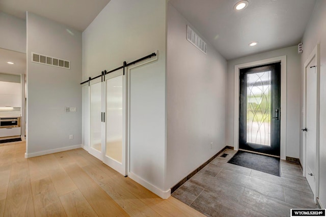 foyer featuring a barn door and light wood-type flooring