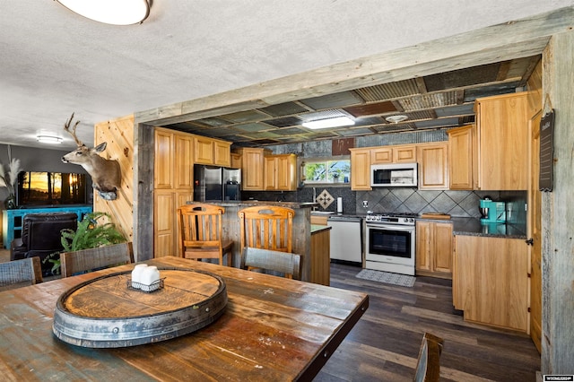 dining room featuring a textured ceiling and dark hardwood / wood-style floors