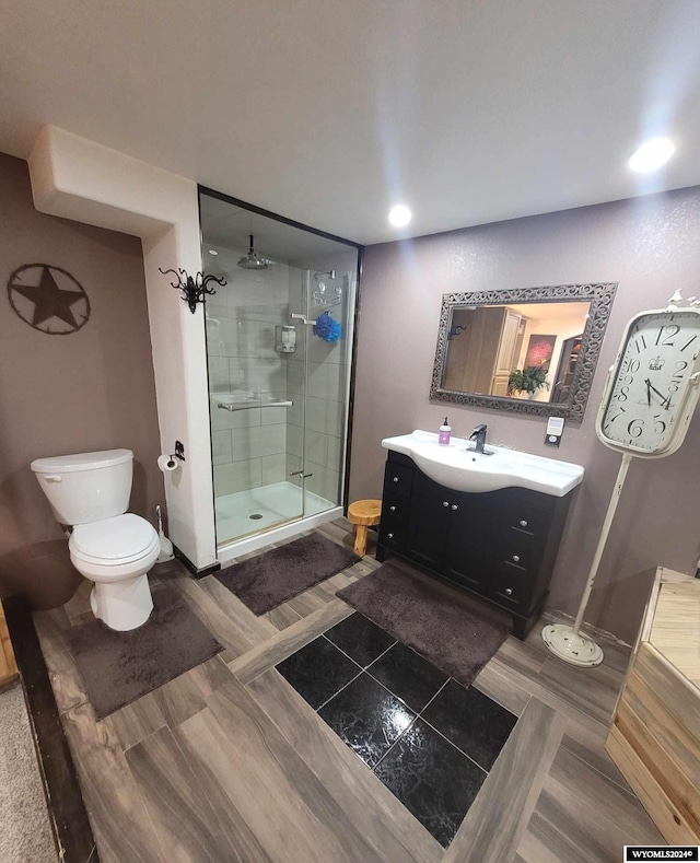 bathroom with vanity, toilet, and walk in shower