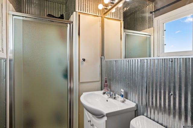 bathroom with vanity, toilet, and an enclosed shower