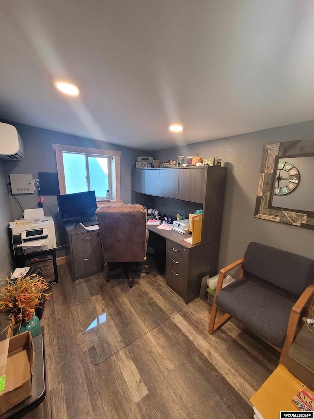 office with dark hardwood / wood-style flooring and a wall unit AC