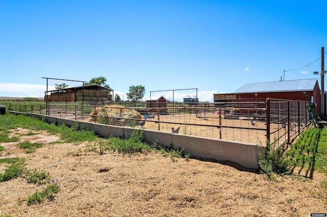 view of yard with a rural view and an outbuilding