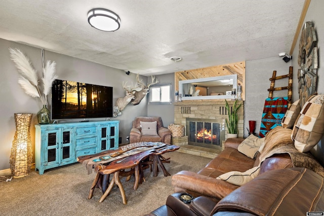 carpeted living room featuring a fireplace and a textured ceiling