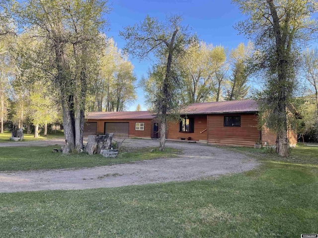 ranch-style house with a front yard and a garage