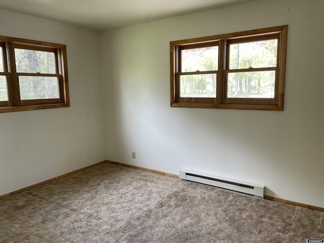 carpeted spare room with a baseboard radiator