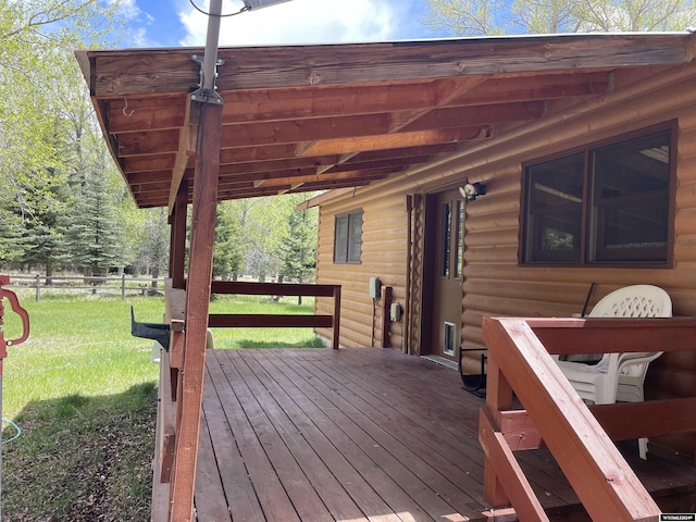 wooden terrace featuring a yard