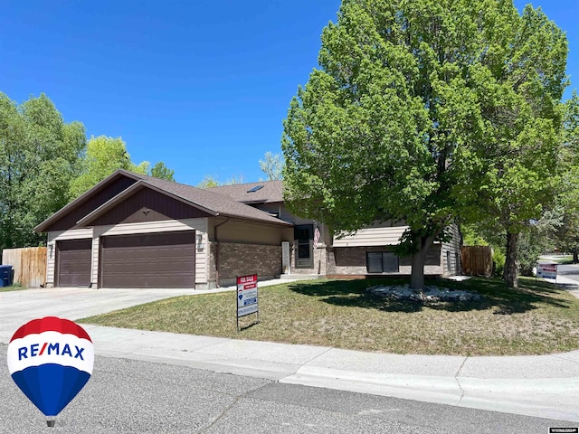 view of front facade with a garage and a front lawn