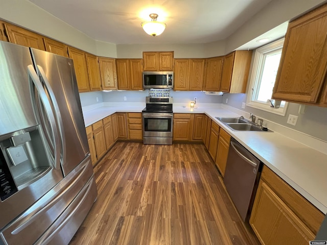 kitchen with dark wood-type flooring, sink, and stainless steel appliances