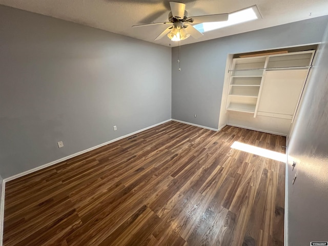 unfurnished bedroom featuring a closet, dark wood-type flooring, and ceiling fan