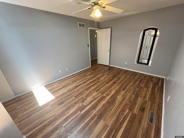 spare room featuring dark hardwood / wood-style floors and ceiling fan