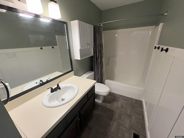 full bathroom with parquet flooring, shower / bath combination with curtain, vanity, and toilet