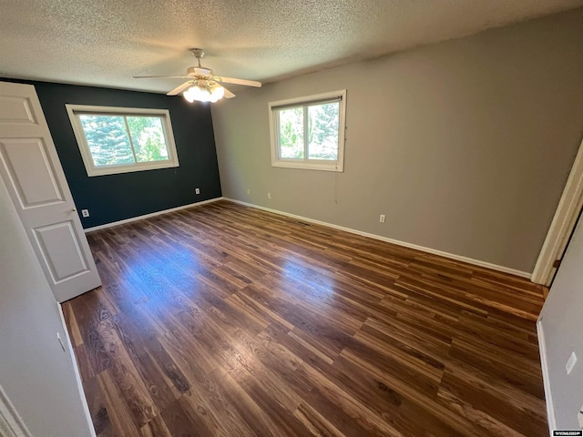 unfurnished bedroom featuring a textured ceiling, multiple windows, ceiling fan, and dark hardwood / wood-style floors