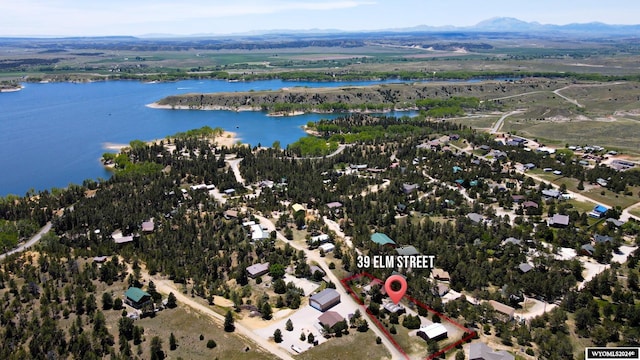 drone / aerial view featuring a water and mountain view