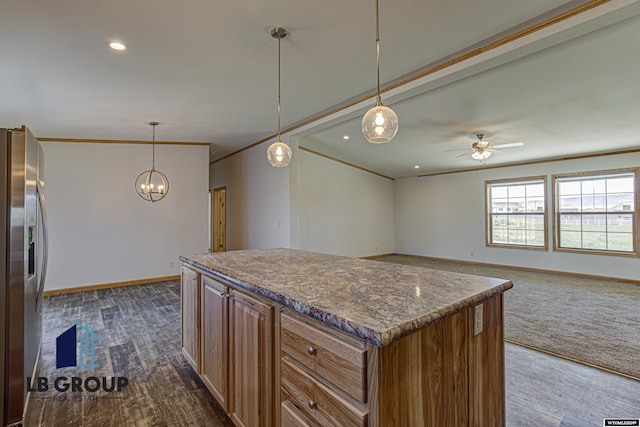 kitchen with crown molding, stainless steel fridge, a center island, and pendant lighting