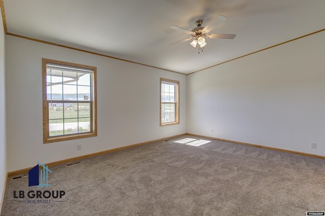 carpeted empty room featuring ornamental molding and ceiling fan