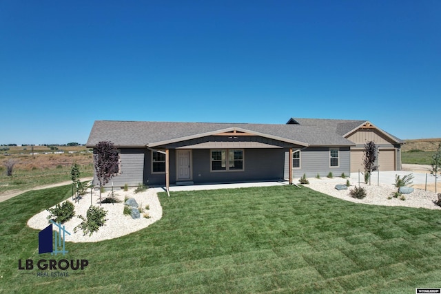 ranch-style house featuring a garage and a front yard