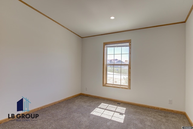 carpeted spare room with crown molding