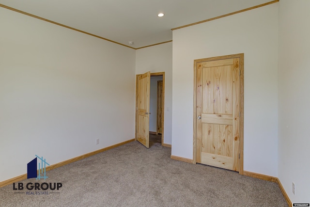 spare room featuring ornamental molding and carpet floors