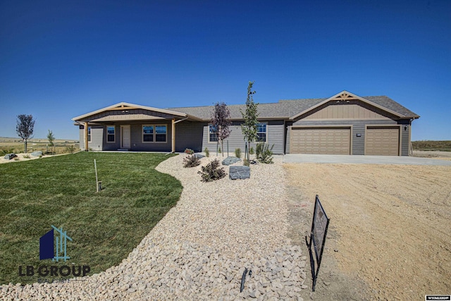 ranch-style house featuring a garage and a front yard